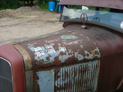 2001 Ford Fiesta - This vehicle's hood displays painted bowling pins and the words "TARGET TONIGHT" amidst significant rust.