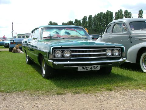 2001 Ford Fiesta - Front view of a green 1970 Ford sedan with a cartoon sunshade on the windshield.