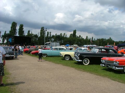 2001 Ford Fiesta - A variety of vintage automobiles are displayed at an outdoor gathering under a cloudy sky.