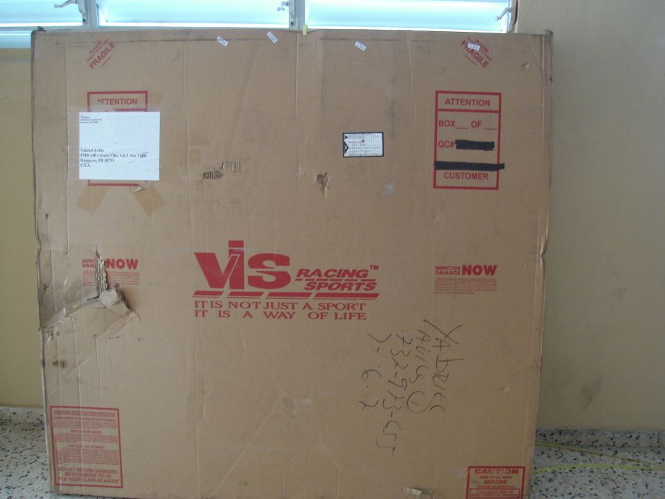 Cardboard box with VIS Racing Sports logo and shipping labels