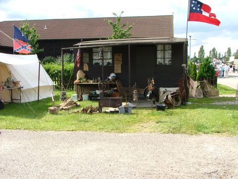 2001 Ford Fiesta - A historical reenactment scene is set up with a tent, a small building, and period-appropriate flags and artifacts.