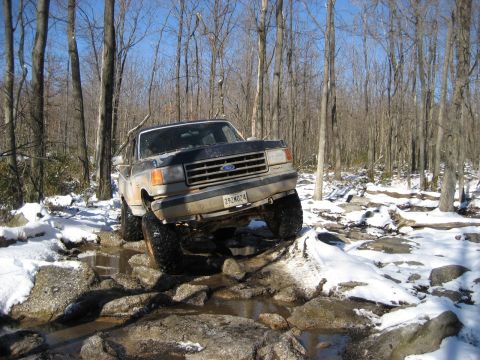 1991 Ford Bronco - This 1991 Ford Bronco tackles a challenging off-road course with snow and rocks.