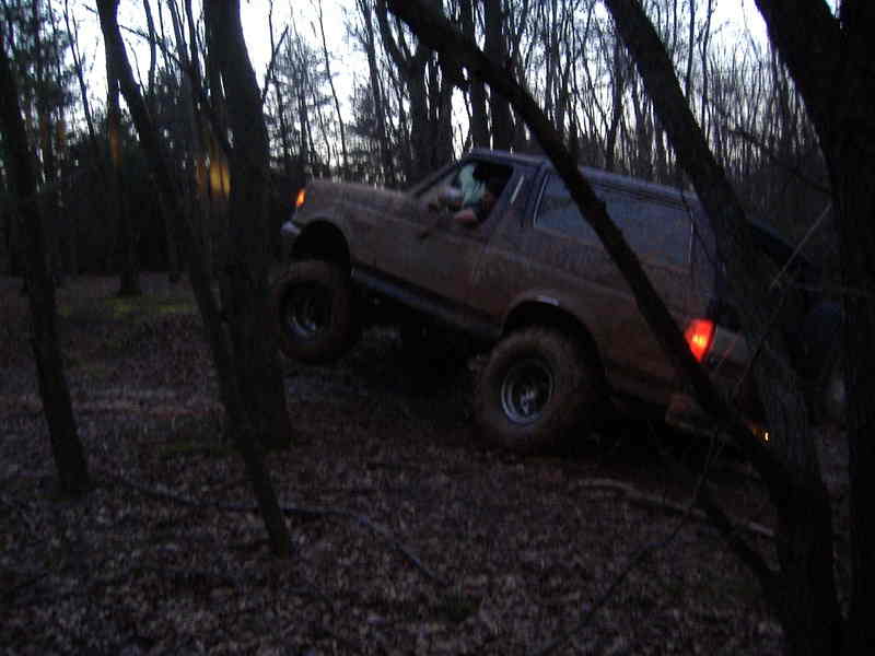 Brown 1991 Ford Bronco driving off-road, 3q-front view