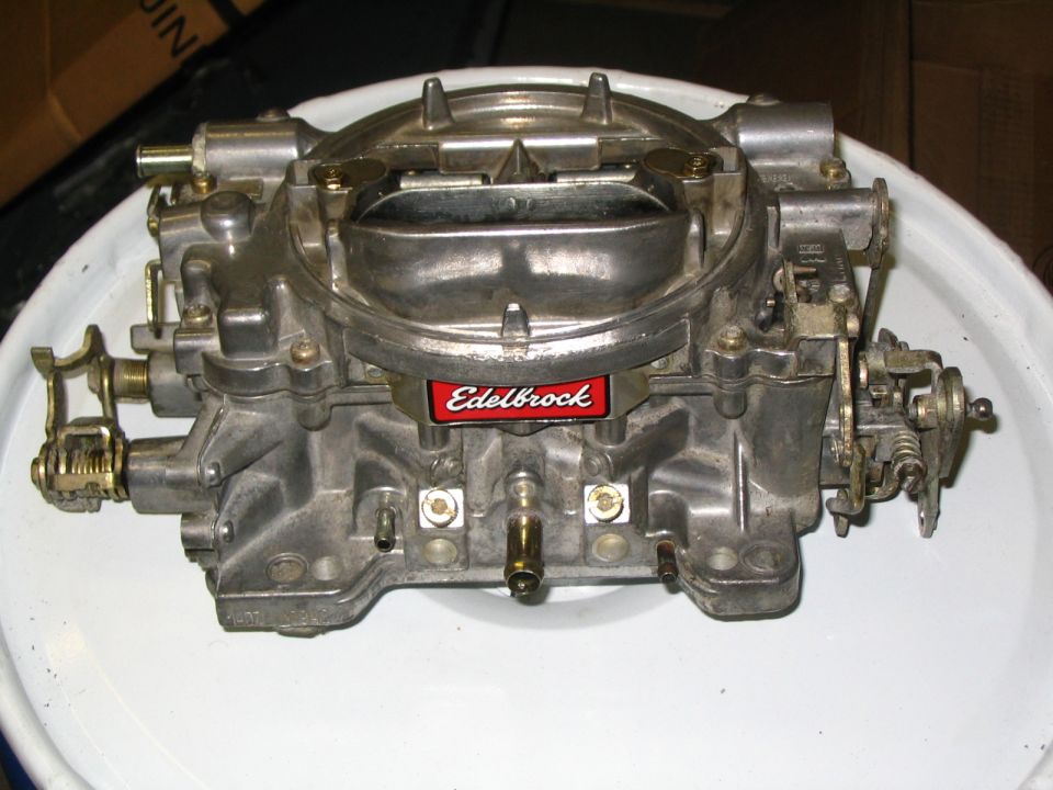 Edelbrock four-barrel carburetor on white bucket