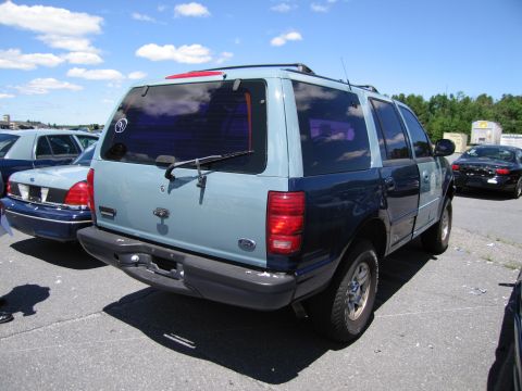 1991 Ford LTD Crown Victoria - Rear view of a two-tone Ford Expedition parked outdoors with other vehicles.