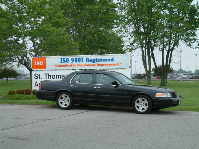 Black 2002 Ford Crown Victoria parked on asphalt, side view