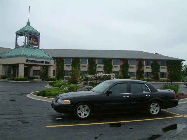 Black 2002 Ford Crown Victoria parked outside a hotel