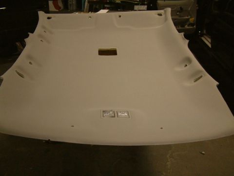 2002 Ford Crown Victoria - A detached car headliner is shown from below, revealing its interior construction and mounting points.