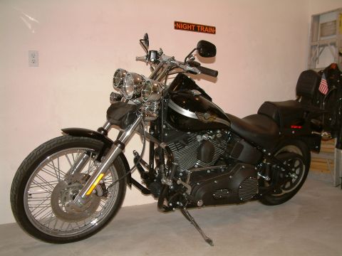 2003 Harley-Davidson Softail - A black Harley-Davidson motorcycle is parked indoors, with a 'Night Train' sign on the wall behind it.