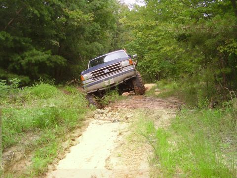 1991 Ford Bronco - This 1991 Ford Bronco navigates a challenging off-road path with steep inclines and loose terrain.