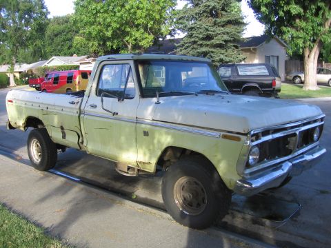 1989 Ford Bronco - This weathered Ford F-150 pickup truck is parked on a residential street.