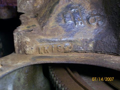 1992 Ford Bronco - Close-up of a rusty engine part showing stamped numbers 'LK189' and 'HMC'.