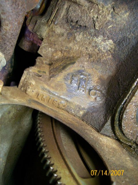 1992 Ford Bronco - Close-up view of stamped casting numbers on a heavily rusted engine block.