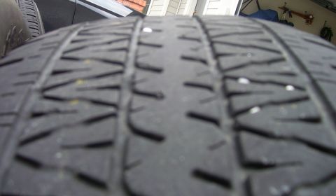 2004 Chevrolet Silverado 1500 - Close-up view of a tire's tread pattern, showing wear and embedded debris.