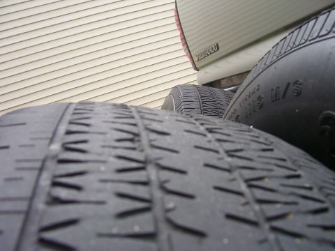 2004 Chevrolet Silverado 1500 - A close-up view of tires in front of a truck bed, revealing the 'Silverado' nameplate.