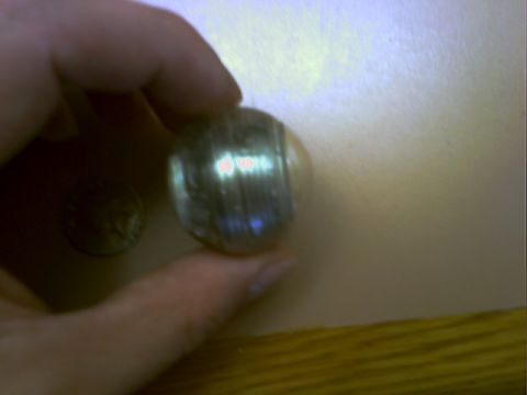 2001 Ford Crown Victoria - A coin is held in a hand, with another coin visible nearby.