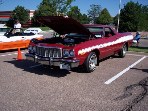 1972 Ford Ranchero - A red 1977 Ford Ranchero is parked with its hood open, displaying its engine, next to another car.