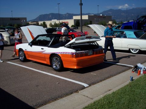 1972 Ford Ranchero - A customized convertible is displayed at an outdoor car show with other vehicles present.