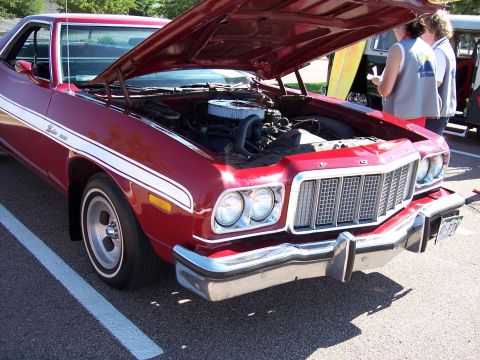 1972 Ford Ranchero - Front view of a red 1972 Ford Ranchero 500 with its hood open at a car show.