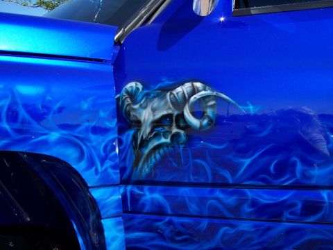 1972 Ford Ranchero - Custom airbrushed blue pickup truck features a skull with ram horns and blue flames along the side panel.