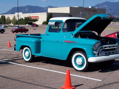 1972 Ford Ranchero - A turquoise and white pickup truck is parked in a lot with its hood open, showing the engine.