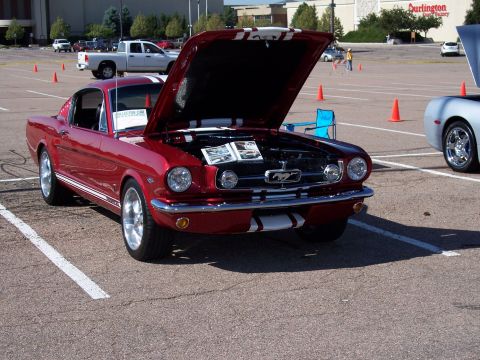 1972 Ford Ranchero - A red classic Ford Mustang is displayed with its hood open at an outdoor event.
