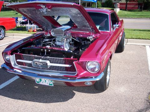 1972 Ford Ranchero - A custom 1967 Ford Mustang is displayed with its hood open, revealing a powerful engine and a prominent air intake scoop.