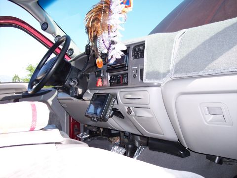 1972 Ford Ranchero - The interior of a vehicle is shown, a GPS mount on the dashboard and decorative items hanging from the rearview mirror.