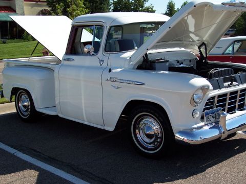 1972 Ford Ranchero - This classic 1955 Chevrolet pickup truck is displayed with its hood and tailgate open, revealing the engine and bed.
