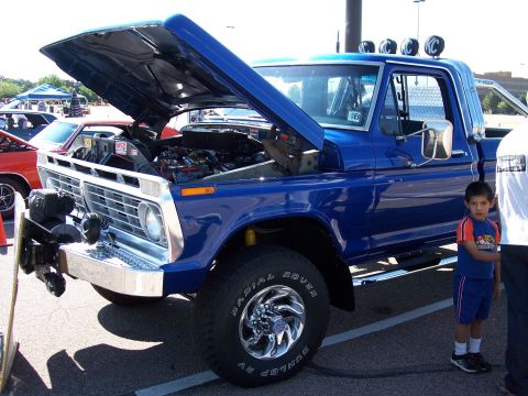 1972 Ford Ranchero - A blue pickup truck, possibly a 1972 model, is displayed with its hood open, revealing the engine compartment.