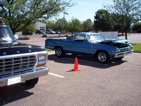 1972 Ford Ranchero - A blue 1968 Ford Ranchero is displayed with its hood open at a car show.