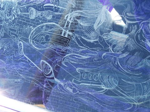 1972 Ford Ranchero - Custom etched glass artwork on a vehicle window features a classic car, a woman's face, and brick wall patterns.