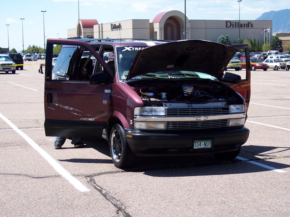 Maroon van with hood and driver's door open, showing engine and interior