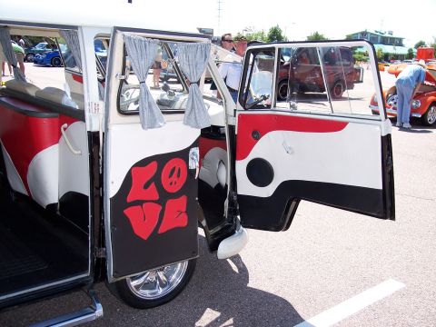1972 Ford Ranchero - A custom painted Volkswagen Type 2 van with its doors open, parked at an outdoor event.