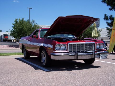 1972 Ford Ranchero - A red coupe utility vehicle is parked with its hood open, revealing the engine bay and front grille.