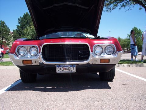 1972 Ford Ranchero - The front of a red 1972 Ford Ranchero is shown with its hood open, revealing the engine bay.