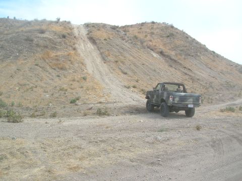 1985 Ford Bronco - This truck appears to be from the early 1980s, possibly a Ford F-150 or similar model, seen here in a dry, hilly landscape.