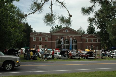 2000 Ford Mustang - Outdoor car show event held in front of a historic bottling plant building.