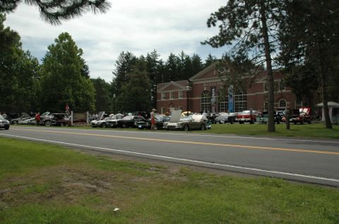 2000 Ford Mustang - A variety of cars are on display in front of a building during an outdoor event.