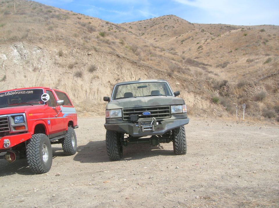 Camouflaged Ford Bronco with winch and aftermarket bumper