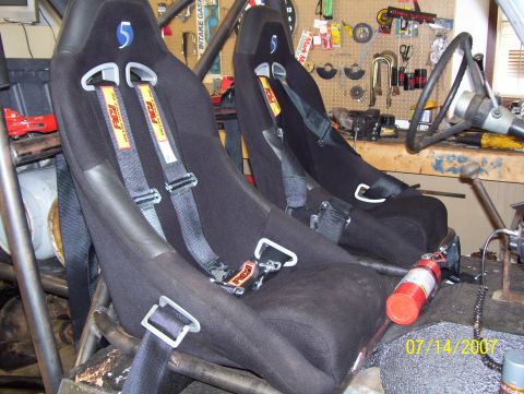 1978 Ford Bronco - Interior view of racing seats and roll cage, with a fire extinguisher mounted nearby.