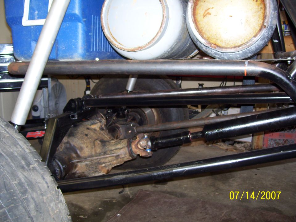 close-up of a vehicle's rear differential, driveshaft, and suspension components