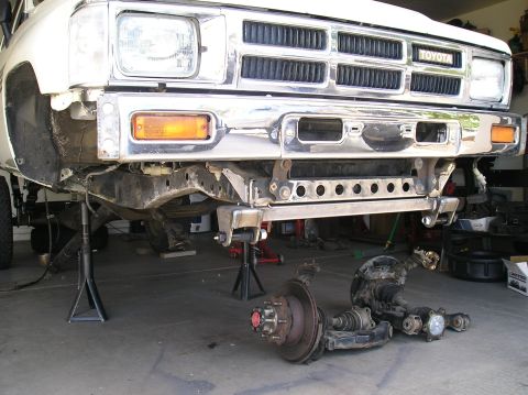 1986 Toyota Hilux - Front suspension components removed from a white Toyota truck, which appears to be from the early 1980s.