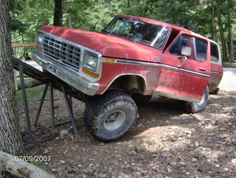 1978 Ford Bronco - A red 1978 Ford Bronco is positioned on a metal ramp, with its front wheels higher than the rear.