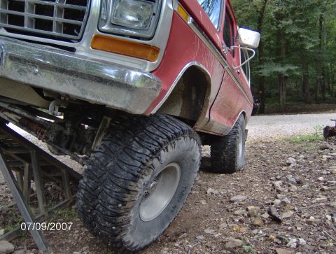 1978 Ford Bronco - A red 1978 Ford Bronco is shown from a low angle, with its front tire on a ramp.