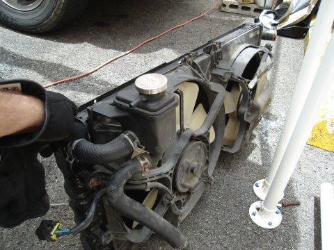 1995 Mazda MX-6 - A radiator and fan assembly is shown, likely removed from a vehicle for repair or replacement.