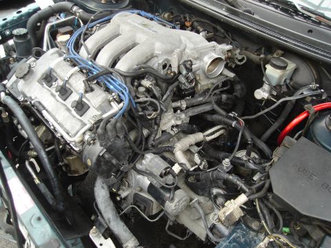 1995 Mazda MX-6 - Close-up view of a V6 engine bay, showing various components and wiring.