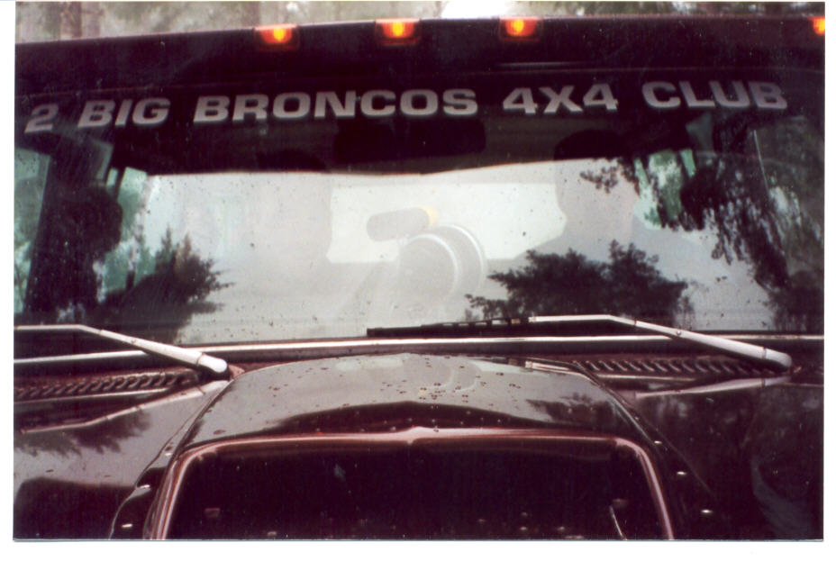 Windshield banner reading 2 BIG BRONCOS 4X4 CLUB above a hood and roof rack