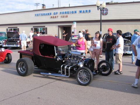 1989 Ford Mustang - A custom hot rod is displayed at an outdoor car show event.