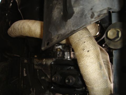 1995 Mazda MX-6 - Exhaust pipes wrapped in heat insulation, likely part of a turbo project.